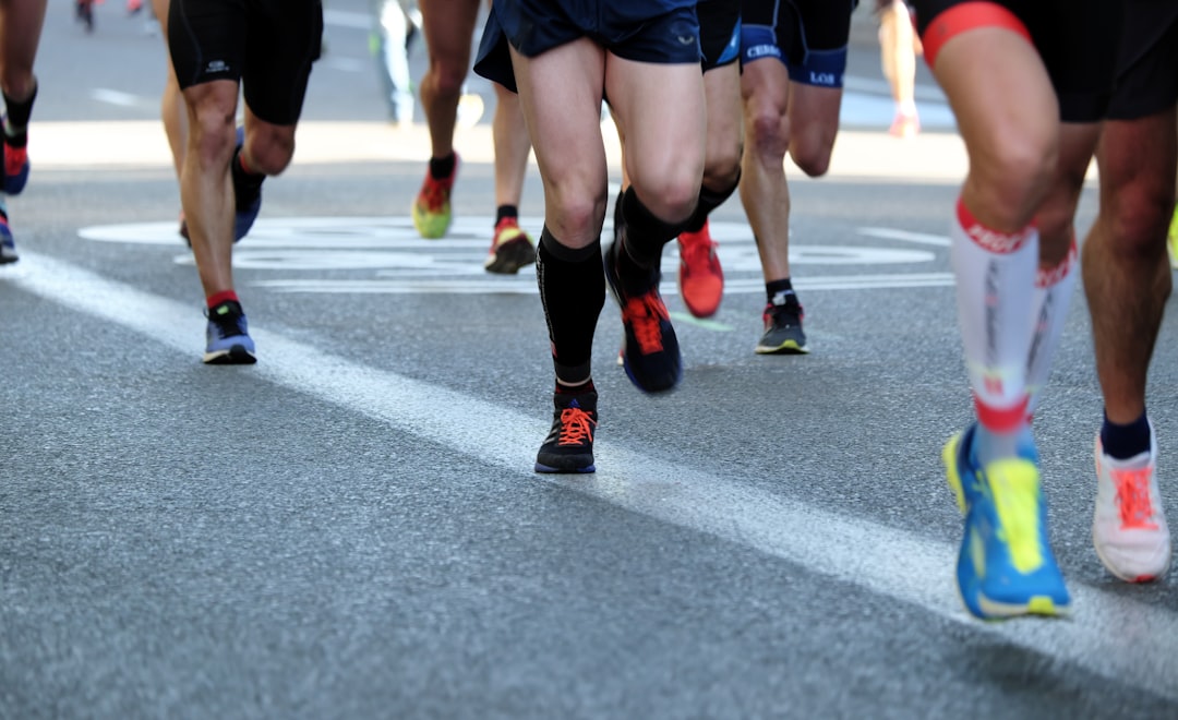 people-running-on-gray-asphalt-road-during-daytime-y0woumyxgrw